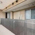 コスモ北新横濱ステーションフロント 玄関前には格子状の扉が設けられ、防犯面に配慮されています。モニタ付きインターホンも備わっています。